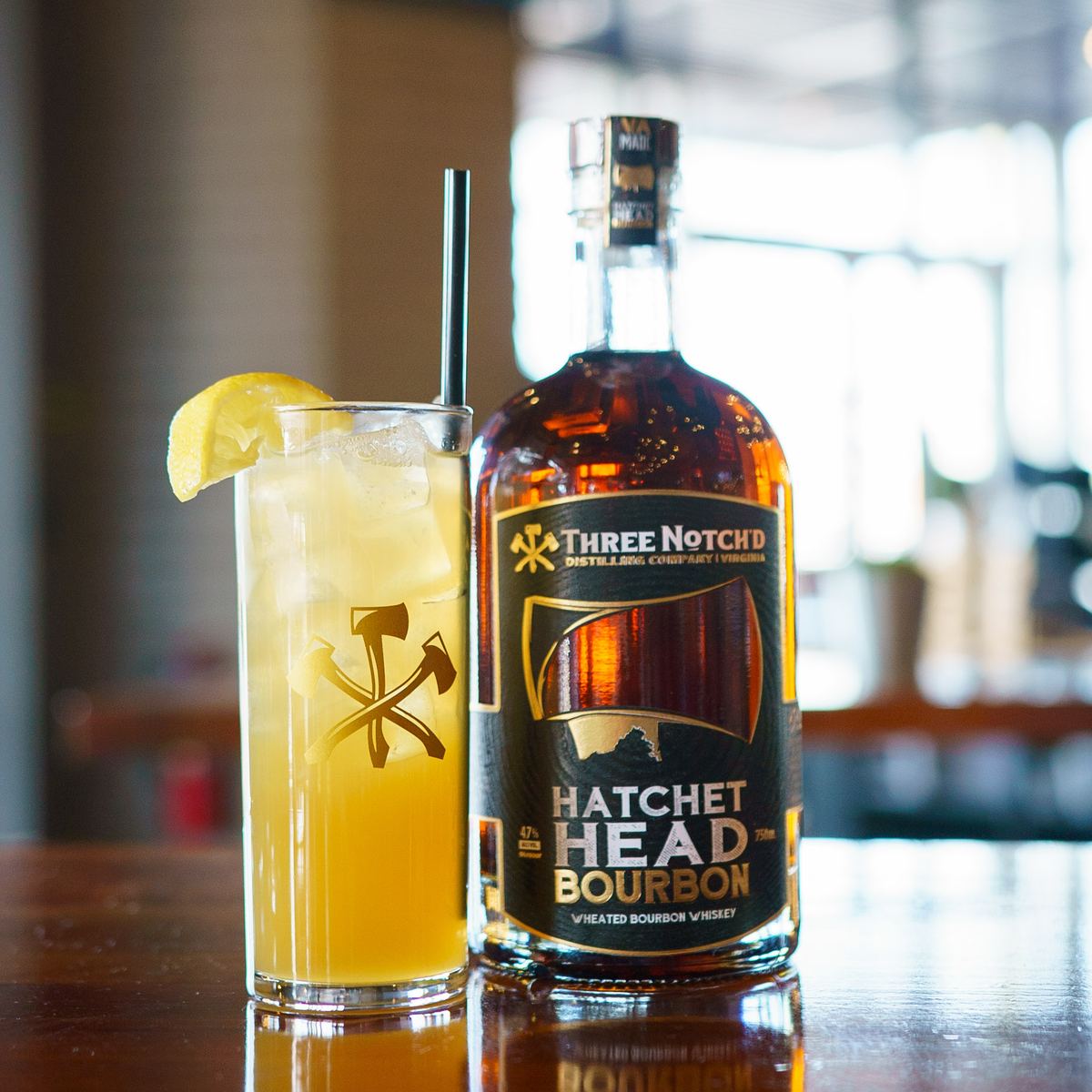 A bottle of Hatchet Head Bourbon beside a highball