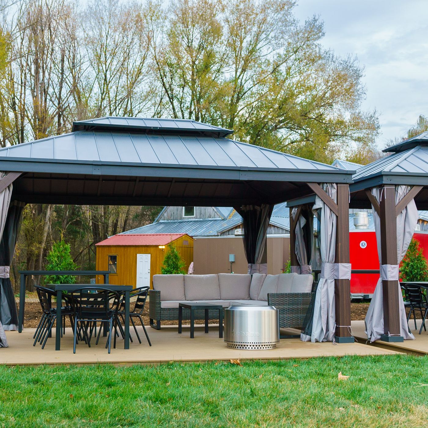 Two gazebo cabanas with lounge seating on the lawn
